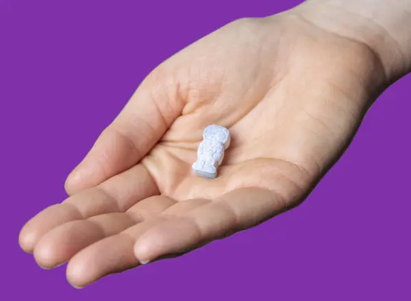 StarMulti chewable tablet in the palm of a hand