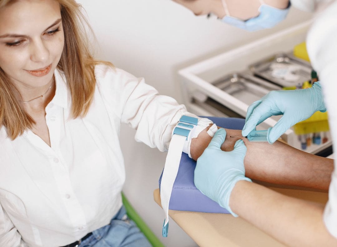 woman getting blood taken from her left arm for a blood test